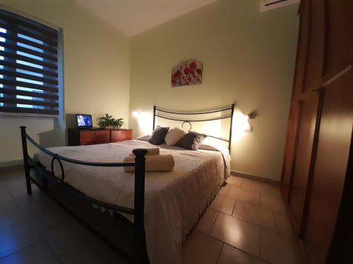 a bedroom with a bed and a window at Casa Giampiero in Villaputzu