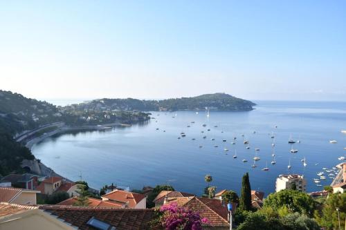 a view of a harbor with boats in the water at French Riviera - 3 pièces, vue mer et piscine in Villefranche-sur-Mer