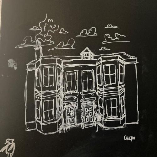 a drawing of a house on a chalkboard at Argyle Backpackers in Edinburgh