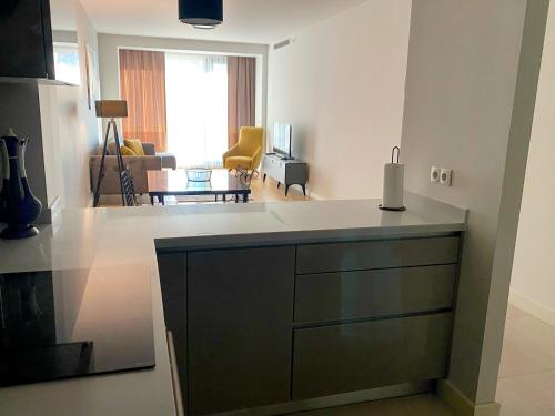 a kitchen with a counter top and a living room at The Y Istanbul Suites in Istanbul