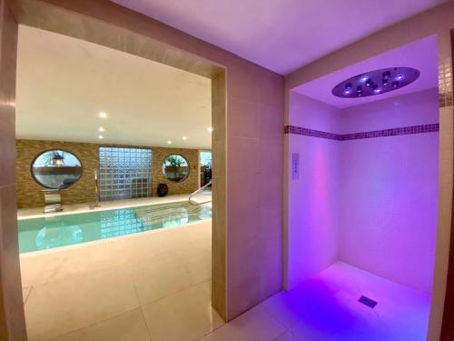 a house with a swimming pool with purple lighting at La Lune De Mougins - Hotel & Spa in Mougins