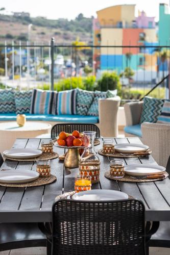 a table with plates of food on a balcony at Marina Sol by Atlantic Places in Albufeira