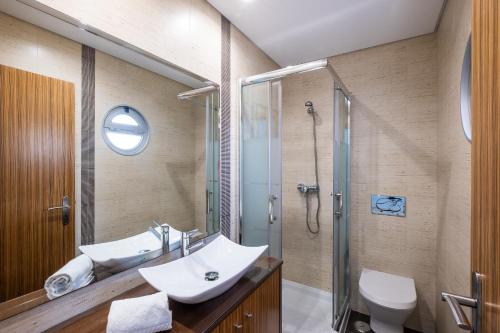 a bathroom with a sink and a shower and a toilet at Marina Sol by Atlantic Places in Albufeira