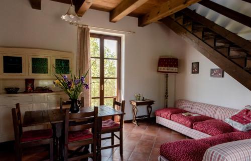 a living room with a couch and a table at Cascina Delle Rose in Barbaresco