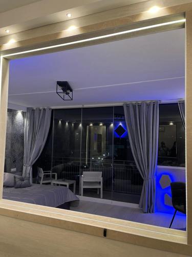 a master bedroom with a large window with a bed and a view at Affittacamere La Magnolia in Bacoli