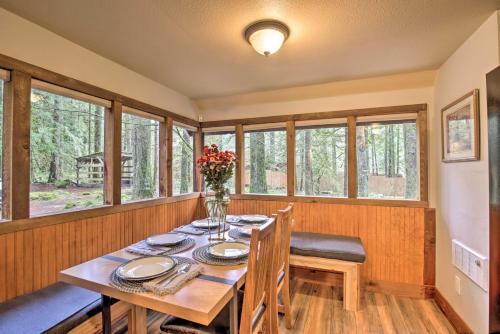 a dining room with a table and chairs and windows at Walk to Zigzag River The Sundance Cottage in Rhododendron