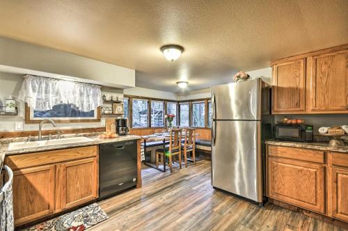 a kitchen with a stainless steel refrigerator and wooden cabinets at Walk to Zigzag River The Sundance Cottage in Rhododendron