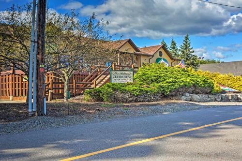 a house with a sign on the side of the road at Large Deck and Resort Amenities Lake Ariel Retreat in Lake Ariel