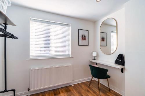 a white room with a mirror and a chair at Charming & Central House with Garden and Free Parking in Beverley