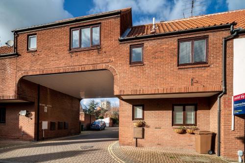an external view of a brick building with an overpass at Charming & Central House with Garden and Free Parking in Beverley