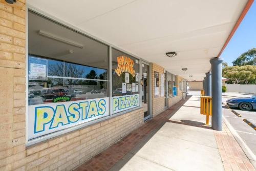 a pasta shop with a sign on the side of a building at A2 Spacious Apartment with WiFi Kitchenette in Perth