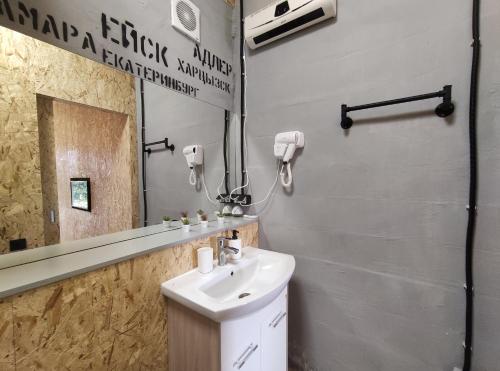 a bathroom with a sink and a mirror at Время Че in Sukhum