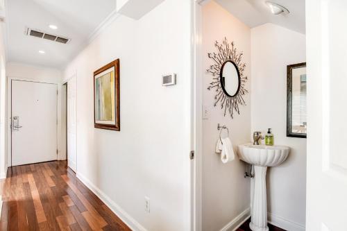a bathroom with a sink and a mirror on the wall at Mariner's Walk 8-A in Isle of Palms
