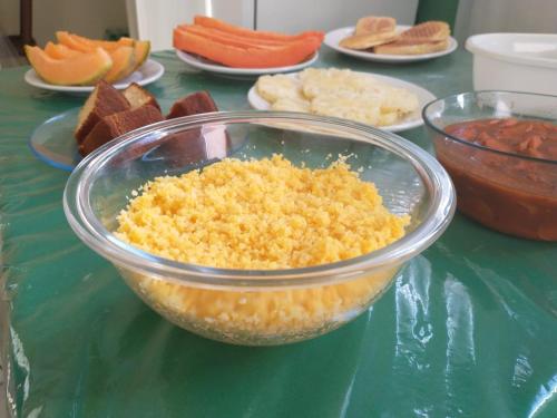 a glass bowl filled with food on a table at Pousada Princesa do Agreste in Passa e Fica