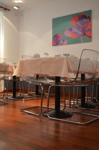 a group of tables and chairs with a table cloth at Hotel Adria in Mestre