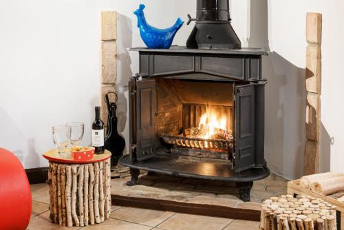 a black fireplace in a room with a table and wine glasses at Casa Kawaii in Cagliari