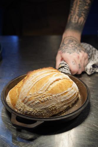 a loaf of bread on a plate on a table at The Peacock Inn in Chelsworth