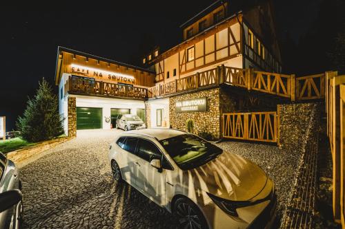 a car parked in front of a building at night at Apartmány Na Soutoku - Březník in Modrava