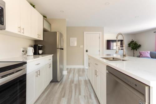 a kitchen with white cabinets and a sink at ENTIRE 2 BEDROOM APARTMENT DOWNTOWN - u2 in Kitchener