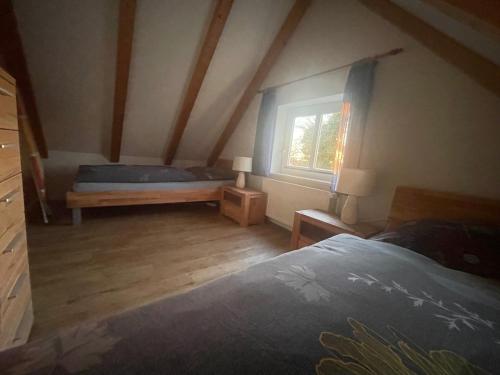 a bedroom with a bed and a window at Ferienhaus Maxe, Haus Paula in Fehmarn
