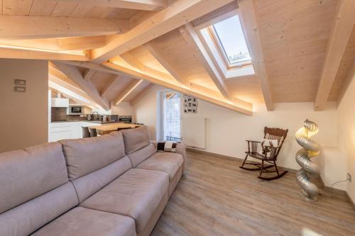 a living room with a couch and a window at Sweet Dolomites Sauna & Jacuzzi in Agordo