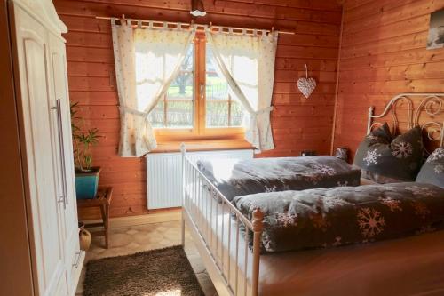 two beds in a room with a window at Ferienhaus Bergglück in Nonnweiler