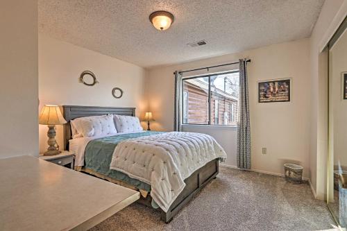 a bedroom with a bed and a large window at The Eagar House White Mountains Gem with Views! in Springerville