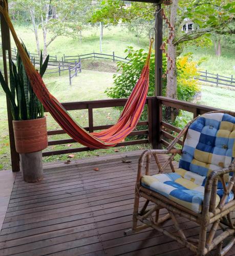 a hammock and a chair on a porch at Condominio Hacienda Shangrila in San Francisco