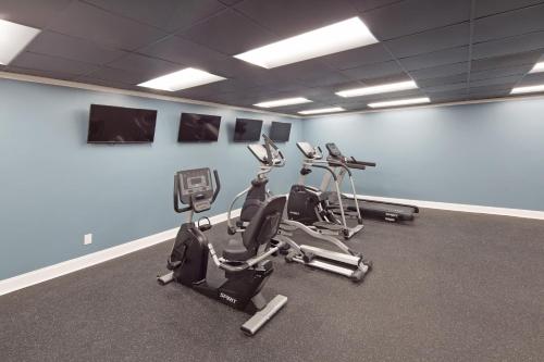 a gym with two exercise bikes in a room at Historic Whispering Woods Hotel & Conference Center in Olive Branch