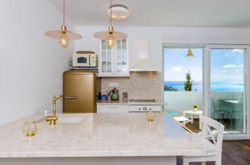 a kitchen with a refrigerator and a counter top at Apartment Rose Dubrovnik in Dubrovnik