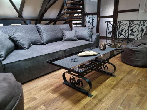 a living room with a couch and a coffee table at Galerie Vila Lucia 5 -Loft apartmán in Plzeň
