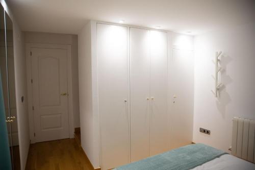 a white bedroom with a bed and a closet at SAN MARCOS in Almansa