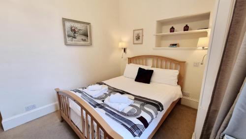 a small bedroom with a bed with towels on it at The Guards Hotel in Edinburgh