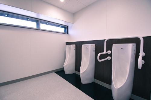 a bathroom with three urinals and a window at Manabiamu 4F - Vacation STAY 43656v in Maizuru