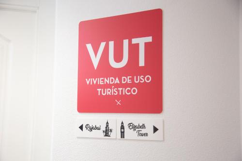 a red exit sign on a wall with arrows at ELIZABETH TOWERS in Almansa