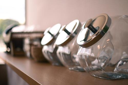 a row of wine glasses lined up on a counter at Manabiamu 4F - Vacation STAY 58913v in Maizuru