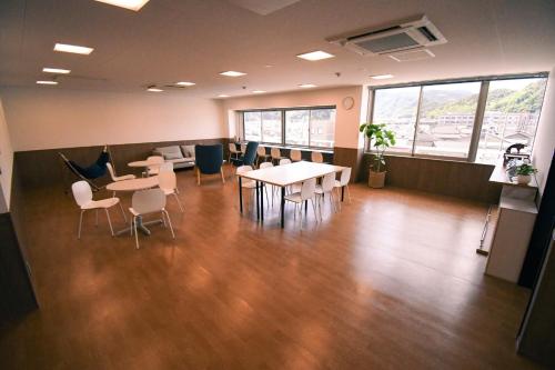 an office with tables and chairs in a room at Manabiamu 4F - Vacation STAY 58913v in Maizuru