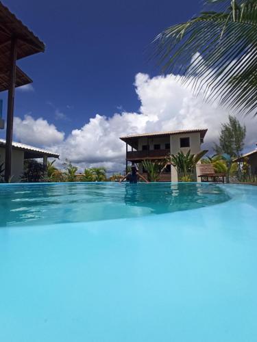 a large swimming pool in front of a house at Bahia Soul - Bangalô Lua - Grupo Barril Hospedagens in Marau