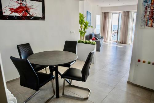 a dining room with a table and chairs at Bella Vista in Ortona