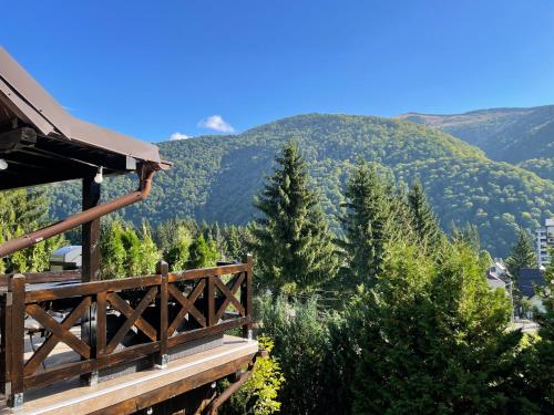 a balcony of a house with a view of mountains at The Nest in Sinaia
