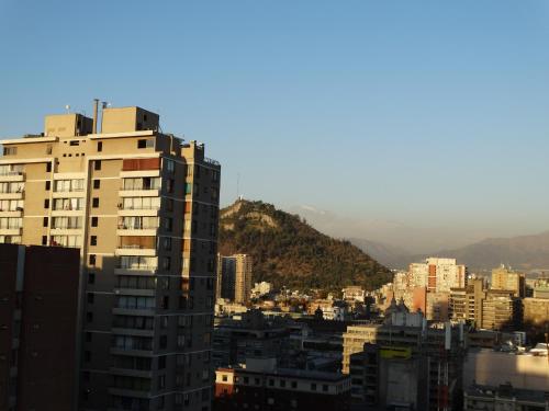 a view of a city with buildings and mountains at Depto 2 Metro Cal y Canto (Estudio) in Santiago