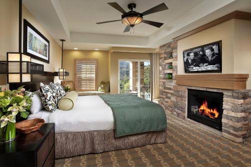 a bedroom with a bed and a fireplace at Hyatt Vacation Club at the Welk, San Diego in Escondido