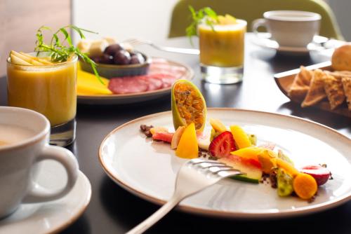a plate of food with a fork on a table at Novotel Arica in Arica