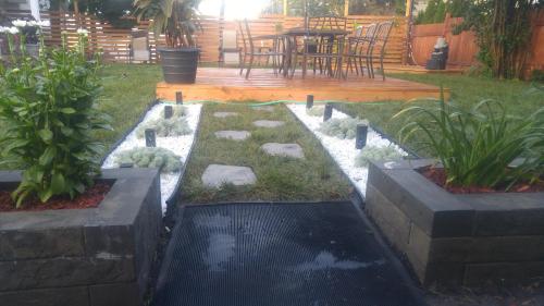 a backyard with a garden with rocks and plants at Auberge Jeunesse à Loulou in Lévis