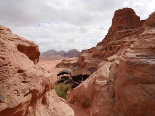 a train traveling through a desert with rocks at Wadi Rum Nights in Wadi Rum