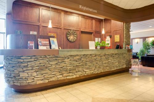 a stone counter in a lobby with a stone wall at Days Inn by Wyndham Calgary South in Calgary