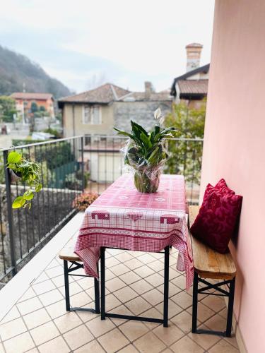 a table with a pink table cloth on a balcony at WINE & LAKE IN FRANCIACORTA in Passirano