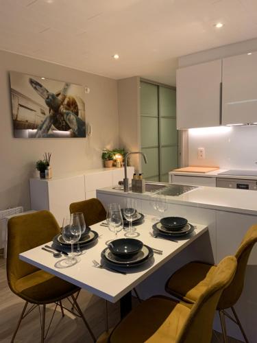 a kitchen with a table with wine glasses on it at SanthooftB 0905 in Nieuwpoort