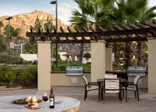 a patio with a table and chairs and a grill at Hyatt Vacation Club at the Welk, San Diego in Escondido