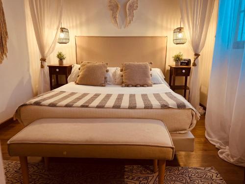 a bedroom with two beds and two tables at Casa Ruy Lopez in Zafra